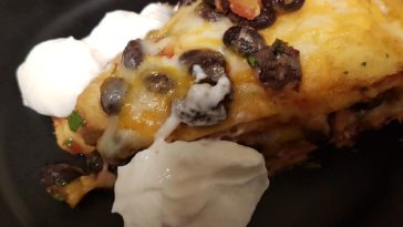 Seven Layer Tortilla Pie Recipe - This casserole is made from pinto and black beans layered with tortillas and cheese. #tortilla #tortillarecipe #tortillapie #tortillapierecipe #sevenlayertortilla #recipes #casserole #casserolerecipe #casserolerecipes #tortillacasserole