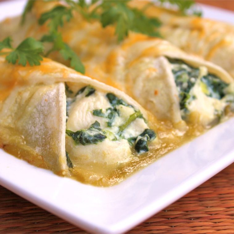 Spinach Enchiladas Recipe - If you like spinach and Mexican food, you'll love these easy vegetarian enchiladas made with ricotta cheese and spinach. #spinach #spinachenchiladas #spinachrecipe #spinachrecipes #spinachenchiladasrecipe #enchiladasrecipe #mexicanfood #mexicanrecipes #vegetarian #vegan #veganrecipes #vegetarianrecipes